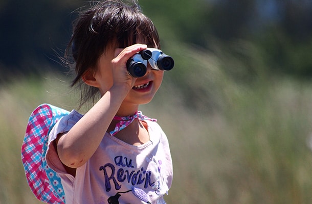 Girl looking through binoculars