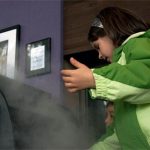 Girl playing with fog exhibit