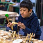 A boy makes a catapult to learn about the physics principle of stored energy.