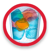 Colored ice cubes in a drinking glass of water
