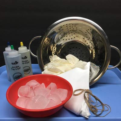 Colander, bowl of ice cubes, rubber bands, fabric, gloves, Tulip one step tie-dye bottles