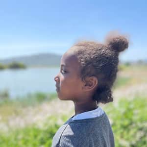 Child with wetlands in background