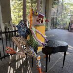Large alebrije sculpture of a boy at a piano.