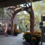 Hummingbird arch placed under the Pavilion at the entrance of the Nature Story Garden. The arch is sculpted to look like bent branches and has hummingbirds all accross the top.