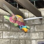 Alebrije sculpture of a tortoise. It is multicolored and with wings.