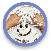 Pair of hands and smiley face drawn in shaving cream